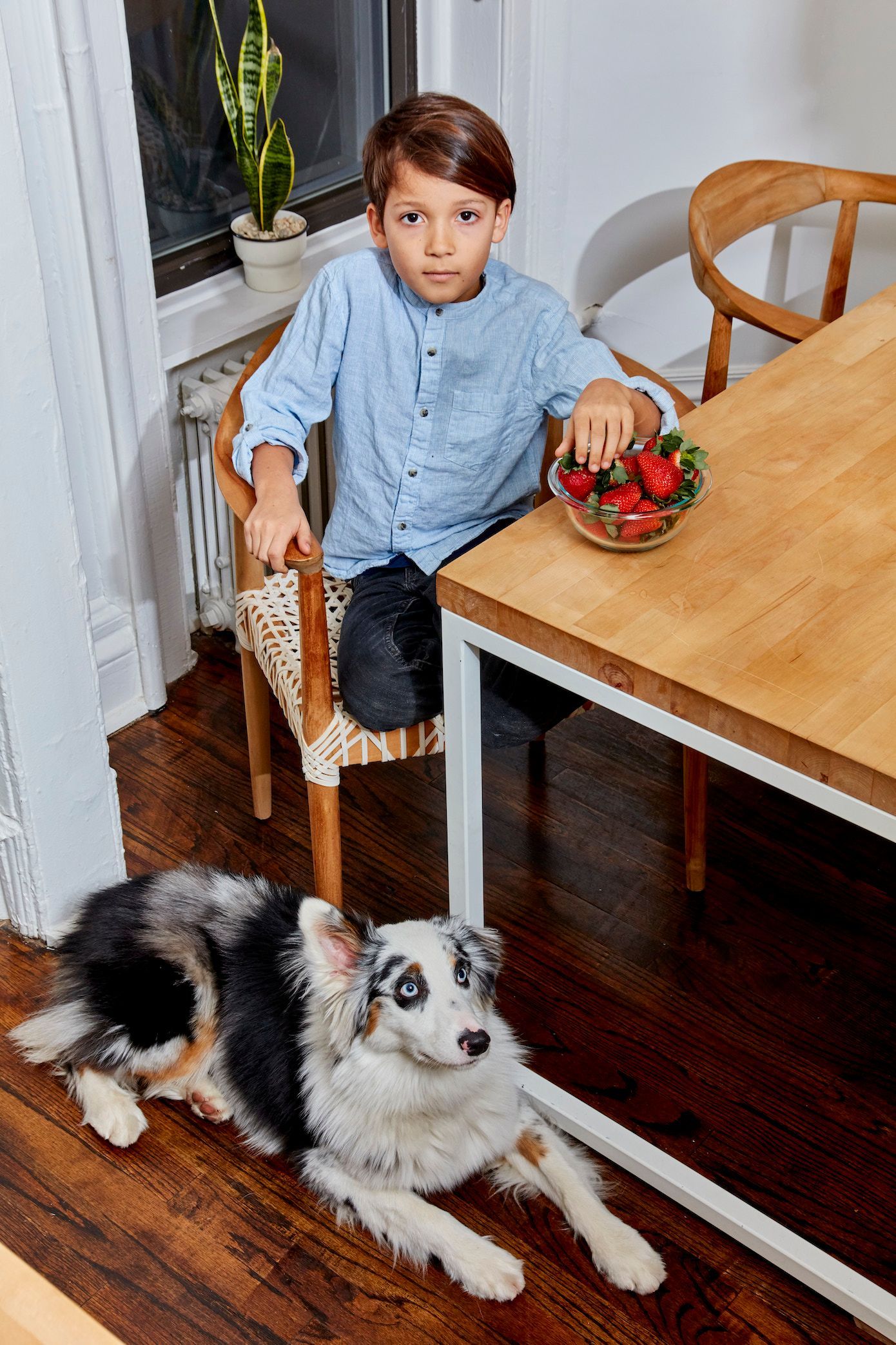 young-boy-eats-healthy-with-his-dog