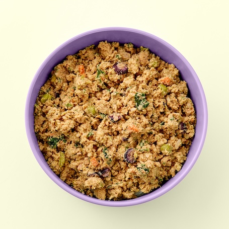 Fresh chicken dog food with diced carrots, vegetables, and gently cooked chicken in a bowl.